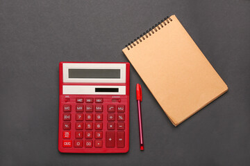 Modern calculator and stationery on dark background