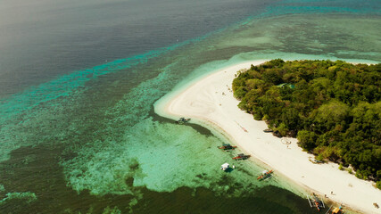 Beautiful beach on tropical island surrounded by coral reef, top view. Mantigue island. Small island with sandy beach. Summer and travel vacation concept, Camiguin, Philippines, Mindanao