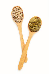 Pumpkin and sunflower seeds on spoon isolated on white