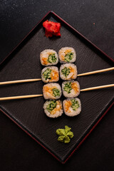 sushi hot rolls on black background dish japanese cuisine