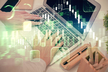 Double exposure of woman hands typing on computer and forex chart hologram drawing. Stock market...