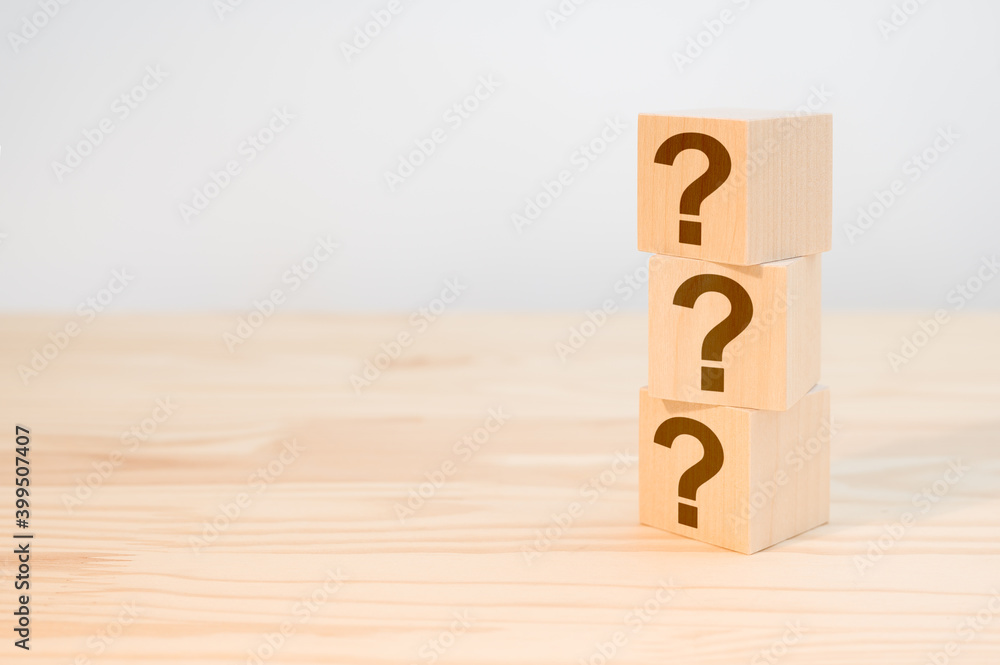 Poster wooden cube block shape with sign question mark symbol on wood table. column of wooden blocks with q