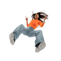 Hair blowing. Young stylish woman in modern street style outfit isolated on white background, shot from the bottom. West fashionable model in sneakers and sweetshirt, musician, rapper performing.