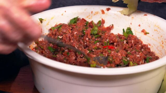 Woman put minced meat with rice and herbs in a cabbage leaf. Preparing for cooking Stuffed Cabbage Rolls,  dolma dish