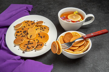front view little pancakes with cup of tea on dark background cake dessert sweet