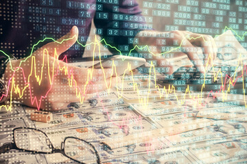 Double exposure of man's hands holding and using a digital device and forex graph drawing. Financial market concept.