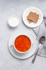 Traditional ukrainian russian soup (borscht) with bread and sour cream