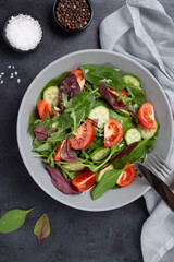 Healthy fresh salad of vegetable cucumber, tomato, spinach, arugula