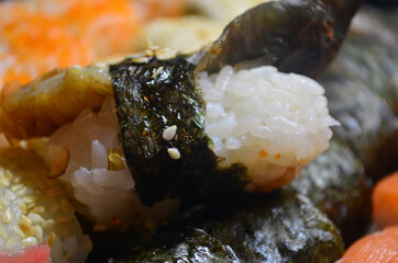 Rolls with salmon and tuna, cream cheese, avocado, eel. Sushi. Figure: