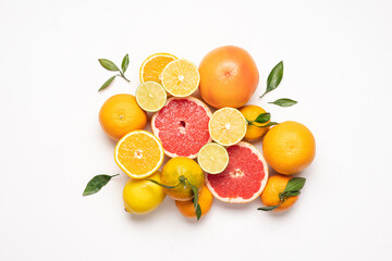 Creative neatly arranged food layout of fruits and leaves on white background.  Healthy food concept. Flat lay juicy citrus fruits  - obrazy, fototapety, plakaty