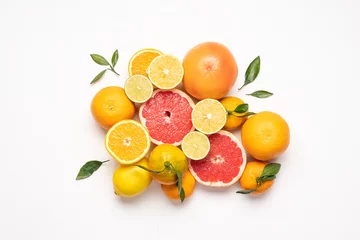 Foto op Plexiglas Creative neatly arranged food layout of fruits and leaves on white background.  Healthy food concept. Flat lay juicy citrus fruits  © Anna Puzatykh