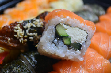 Rolls with salmon and tuna, cream cheese, avocado, eel. Sushi. Figure: