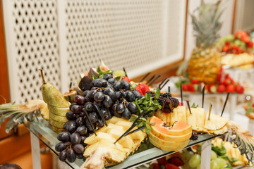 Dessert table for a party. Buffet with delicious fruits. Catering table with different kind of fruits.
