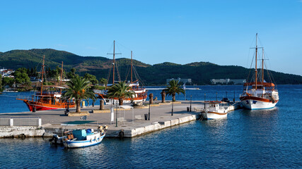 Fototapeta na wymiar Pier and moored sailboats in Neos Marmaras, Greece