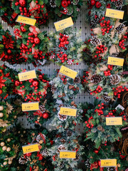 Decorated Christmas wreaths on the shelves in the supermarket.