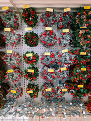 Christmas wreaths are sold on supermarket shelves.