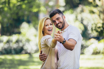 Fototapeta premium Happy couple in love walking in park