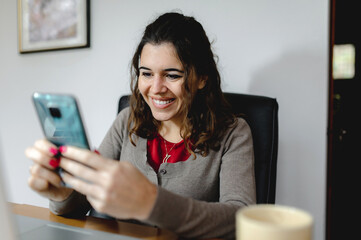 Close-up frontal portrait young smiling attractive woman working at office desk with computer...