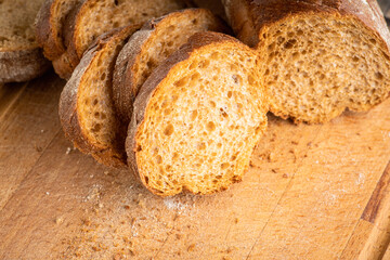 Sliced homemade bread on the wooden cutting board. Selective focus. Shallow depth of field.