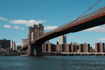View of the New York City, with the Brooklyn Bridge over the river.