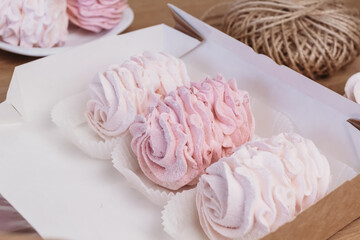 Pink and white marshmallows in gift box. Cozy homemade dessert holidays