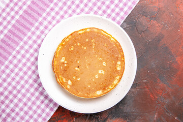 Classic American tasty pancakes on a pink stripped towel on mixed color background