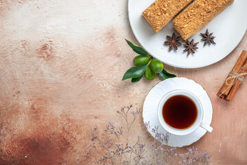 top view tasty cake slices with cup of tea on the light background sweet cake pie biscuit