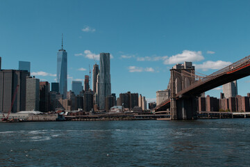 Naklejka premium View of the New York City, with the Brooklyn Bridge over the river.
