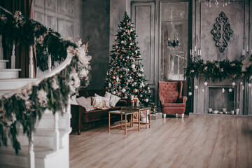 Christmas atmosphere, candles on the background of the Christmas tree and gifts