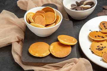 front view little pancakes with cookies on a dark-grey background sweet cake dessert