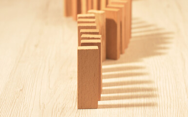A row of a wooden domino falling down.