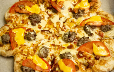 Pizza in the shape of a flower with tomatoes, meatballs, cheese and mozzarella