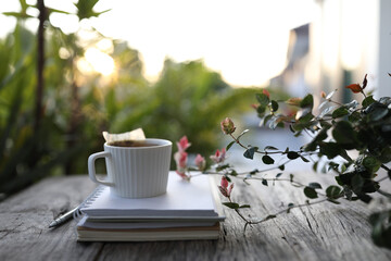 Tea cup with vertical line and plant on wooden table at balcony outdoor
