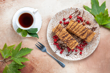 top view yummy cake slice with tea and berries on light background biscuit cakes sweet