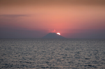 the shooting of the Stromboli volcano during sunset over the sea