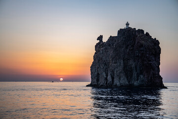 Lighthouse overlooking the sea, on an old inactive volcano, called Strombolicchio. The sunset...