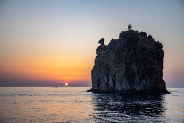 Lighthouse overlooking the sea, on an old inactive volcano, called Strombolicchio. The sunset...