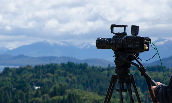 professional video camera with panoramic mountain and lake view