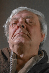 Male portrait of an old man on a dark background