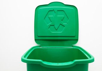 One green trash can for sorting garbage. For plastic or glass or paper