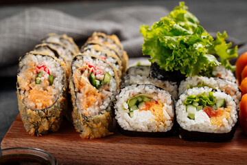 Closeup on sushi roll assorted set on the wooden board with soy sauce