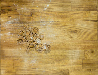 Homemade fresh orecchiette on a wooden surface, top view