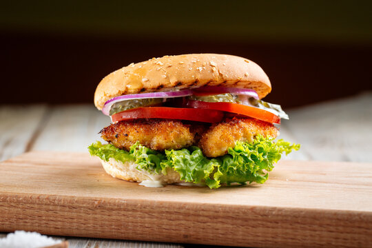 Closeup on zinger burger with deep fried chicken on the wooden table