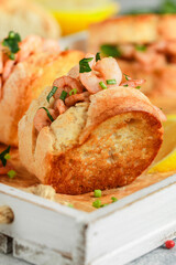 Delicious shrimp and parsley sandwiches, served with lemon and spices. Warm seafood rolls. Selective focus