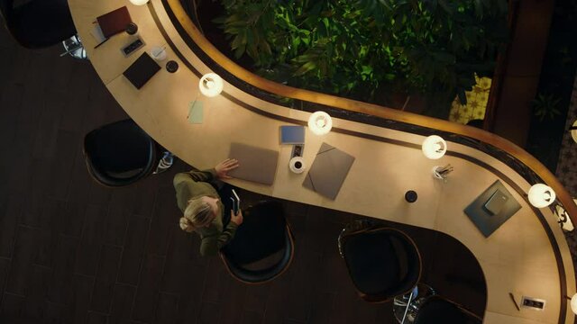 Woman working overtime in coworking. Female freelancer sitting with computer.