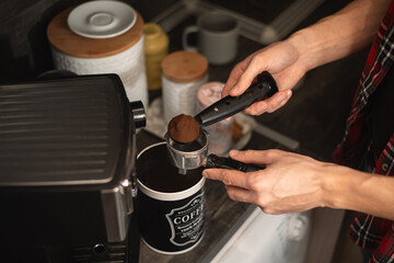 Man making espresso at his coffee station at home. Selective focus