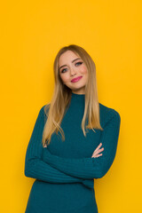 Fototapeta premium Portrait Of Smiling Young Woman In Teal Sweater