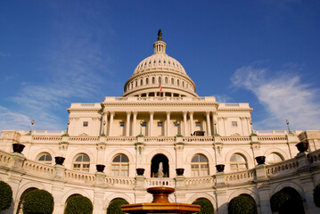 Vue en contre-plongée du Capitole américain, par beau temps, sur fond de ciel bleu.