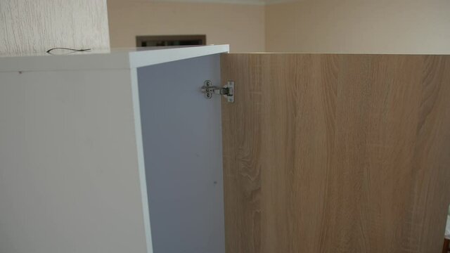Protection of furniture tip over man opens a wardrobe