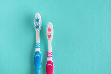 Two clean toothbrushes in blue and red